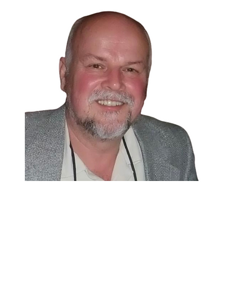 Professional headshot of man in gray blazer smiling at camera for orthodontics practice.