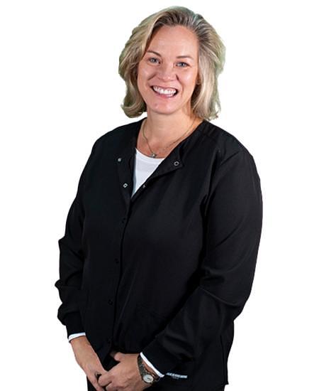Professional woman smiling at camera wearing black jacket against white background.